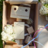 Wooden robot toy in box with flowers