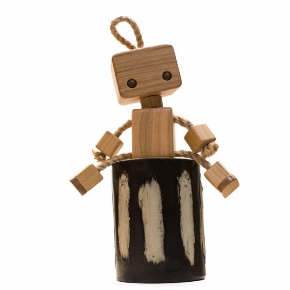 wooden robot toy sitting.