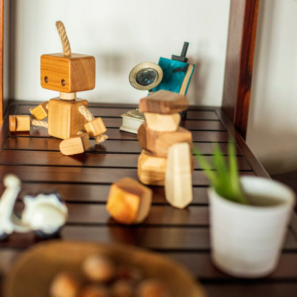 Wooden robot toy sitting on shelf
