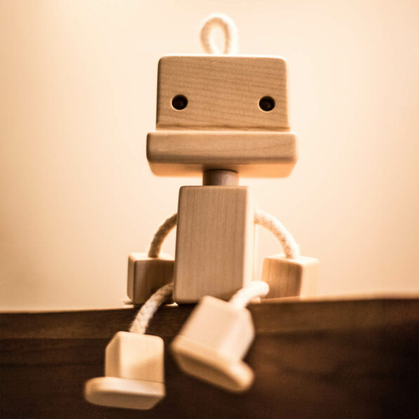 Wooden robot toy sitting