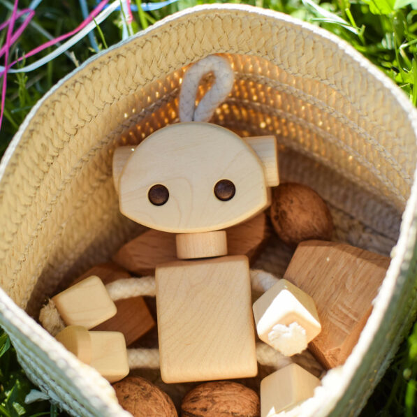 Wooden robot toy in small basket