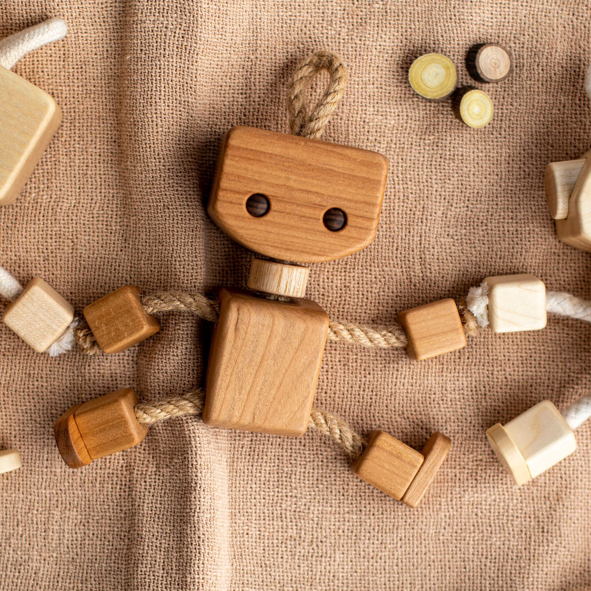 Magical Holiday Play: Creating a Winter Wonderland with Wooden Toys|8 things 4 Wooden robot toy lying on blanket