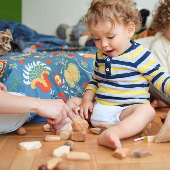 Baby playing with wooden building blocks