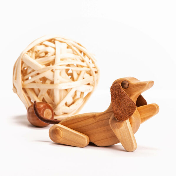 wooden dog toy giving a paw