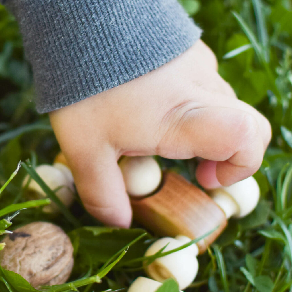 kid hand holding wooden car miniF1 1600x1600 1