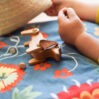 Wooden dog toy and toddlers hand