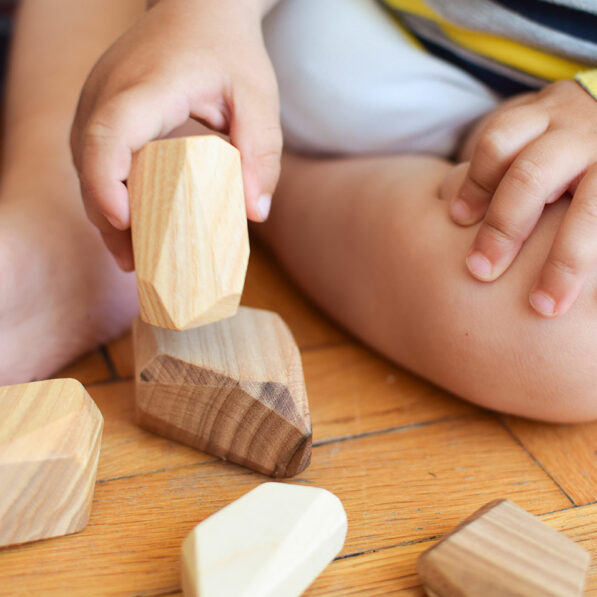 baby hand wooden stones