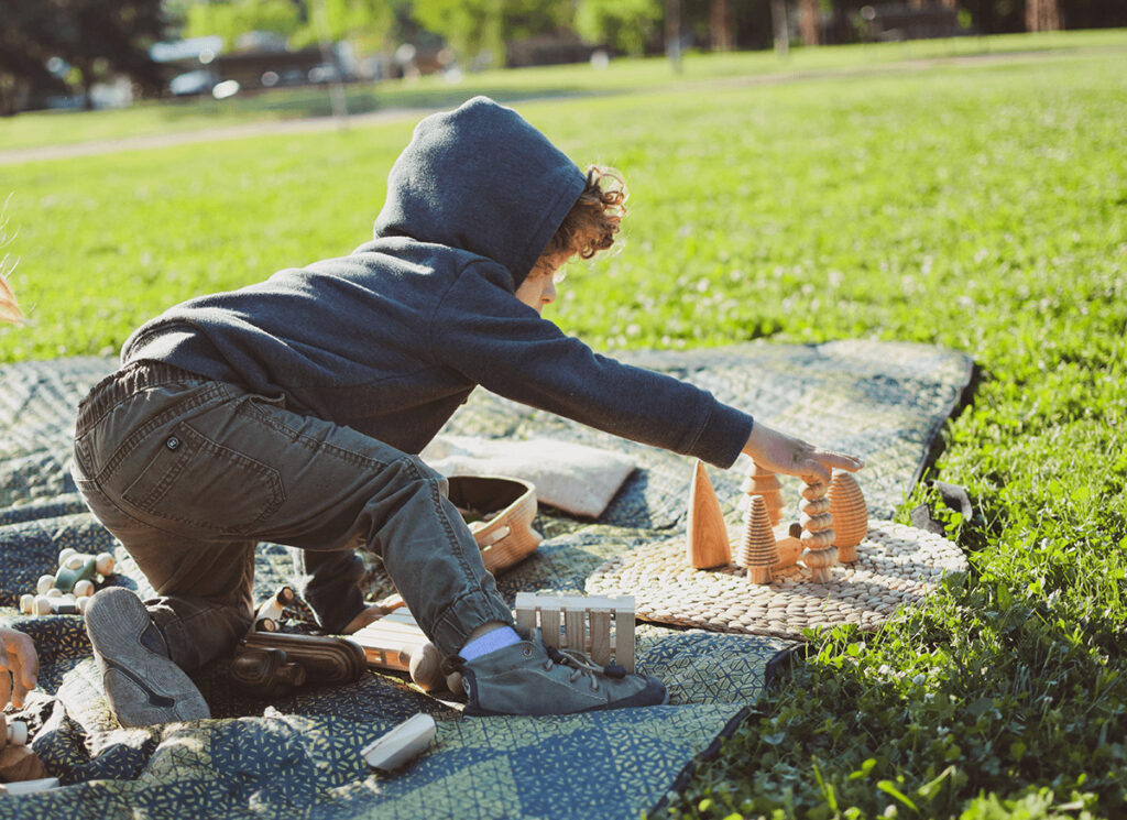 child playng with wooden toys